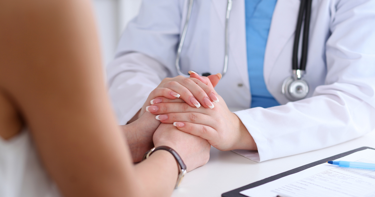 A physician consulting a cancer patient experiencing PTSD
